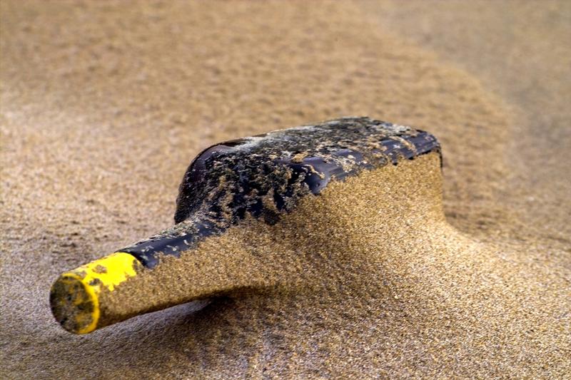 Bottle in sand at an indoor beach party