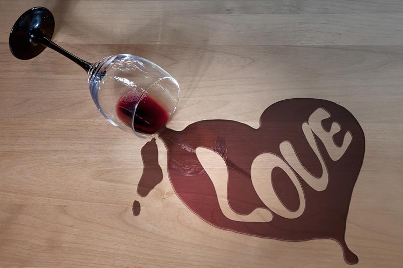 Spilled wine that spells love you may see at a college house party