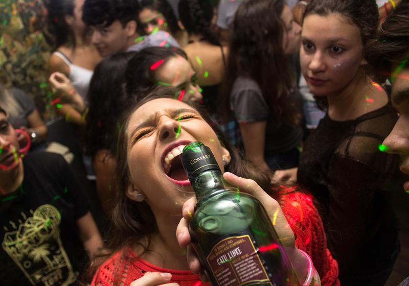 Woman drinking alcohol at a fun rager